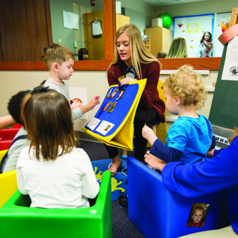 A Fontbonne student works with young clients.