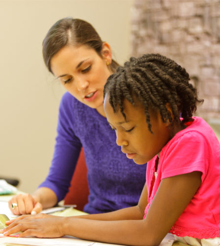 A speech-language pathology student works with a young client.