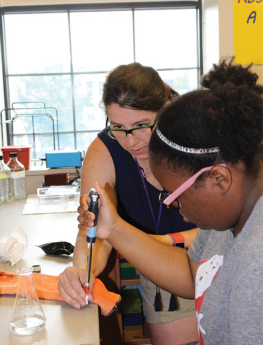 Dr. Kelly Lane-deGraaf works with a young scientist