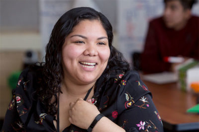 Teacher smiling at student.