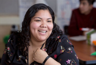 Teacher smiling at student.