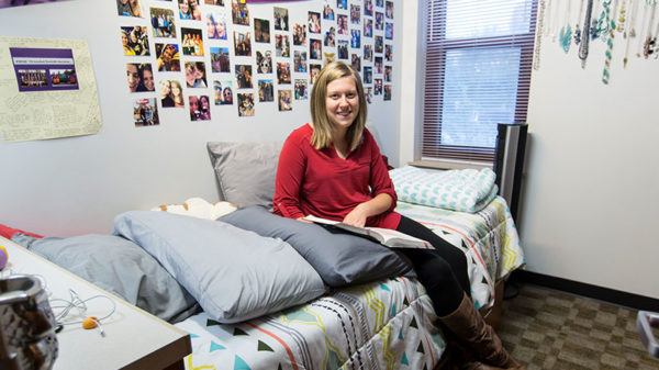 Female student sitting in her apartment.