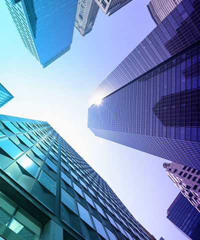 Looking up at sky scraper buildings.