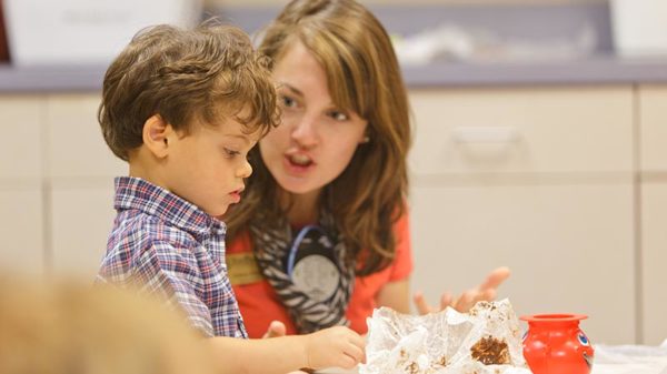 Teacher working with young patient.