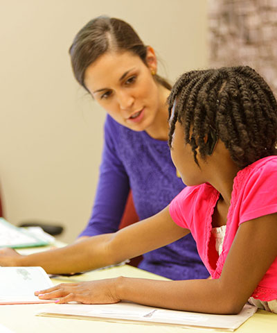 Teacher working with student.