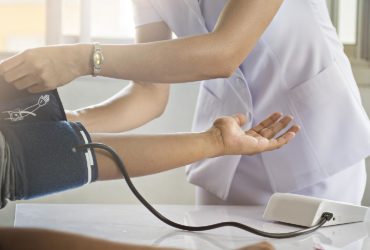 Closeup of nurse working with patient.