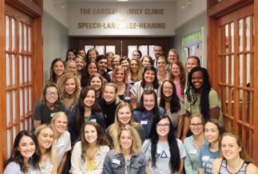 An image of the 40 members of the SLP grad class of 2021 outside the Eardley Family Clinic on Fontbonne's campus.