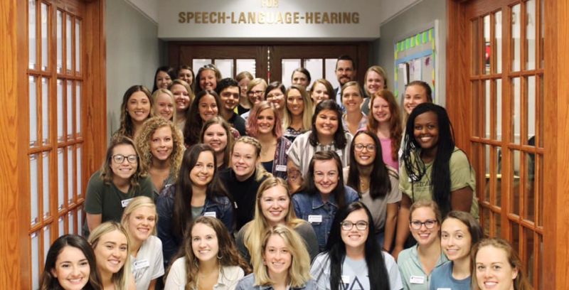 An image of the 40 members of the SLP grad class of 2021 outside the Eardley Family Clinic on Fontbonne's campus.