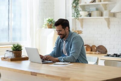 Man at computer in kitchen