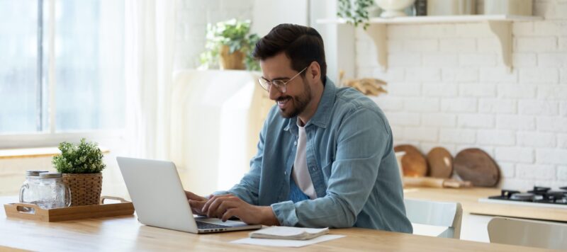 Man at computer in kitchen