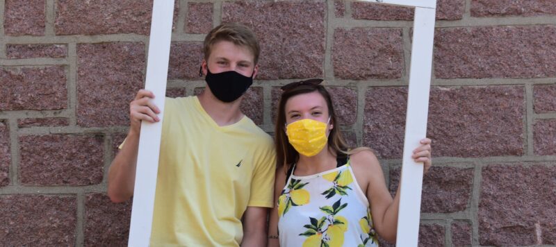 male and female student posing for first day photograph