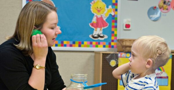 Woman working with deaf child