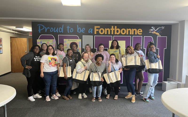 students with matching tote bags